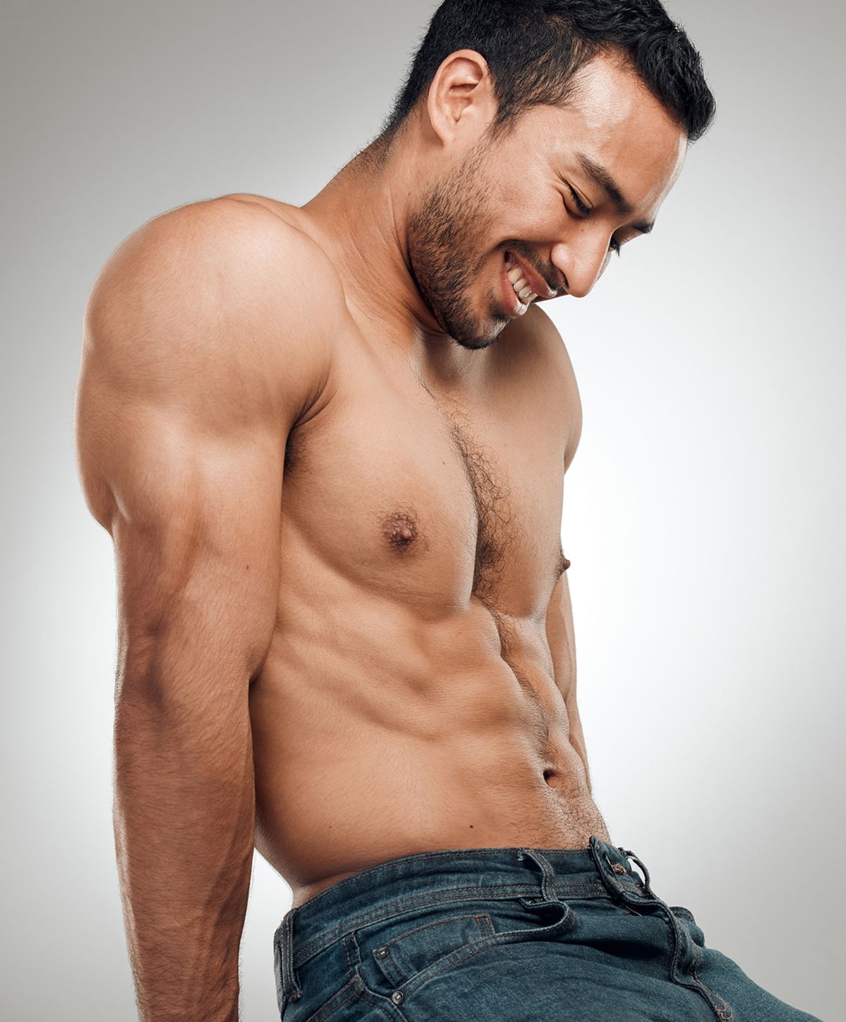 Man with muscular physique and smile.