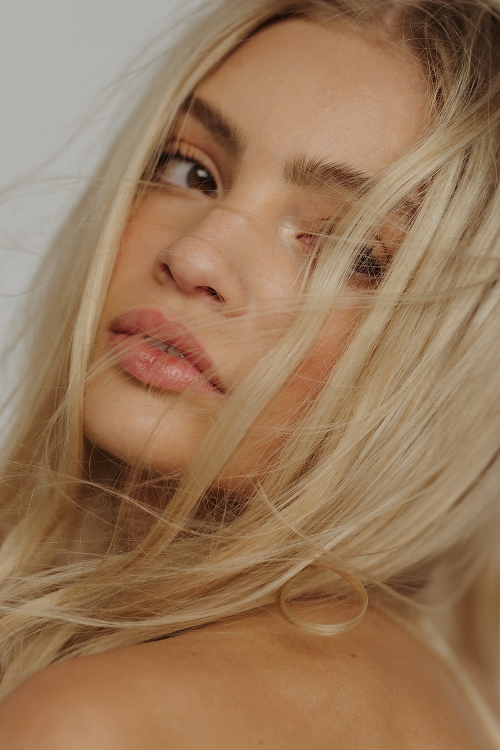 Close-up of a woman with tousled blonde hair.