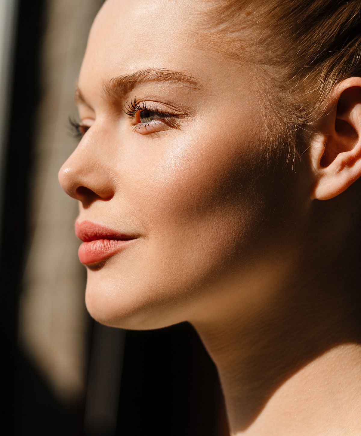 Close-up of a woman's face in sunlight.